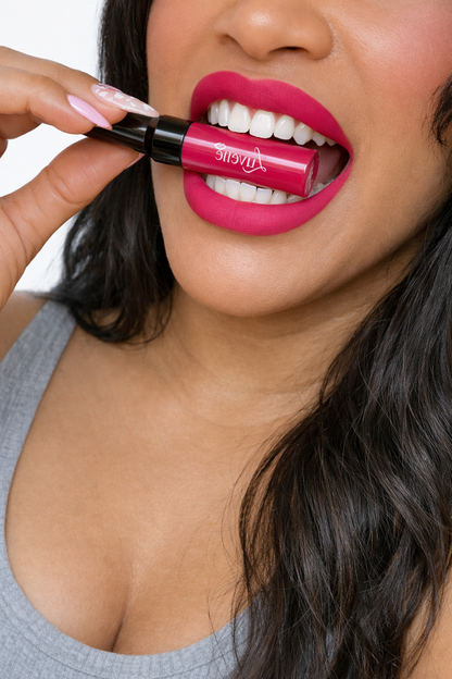 Woman applying pink lipstick with a close-up focus on her lips and the product.