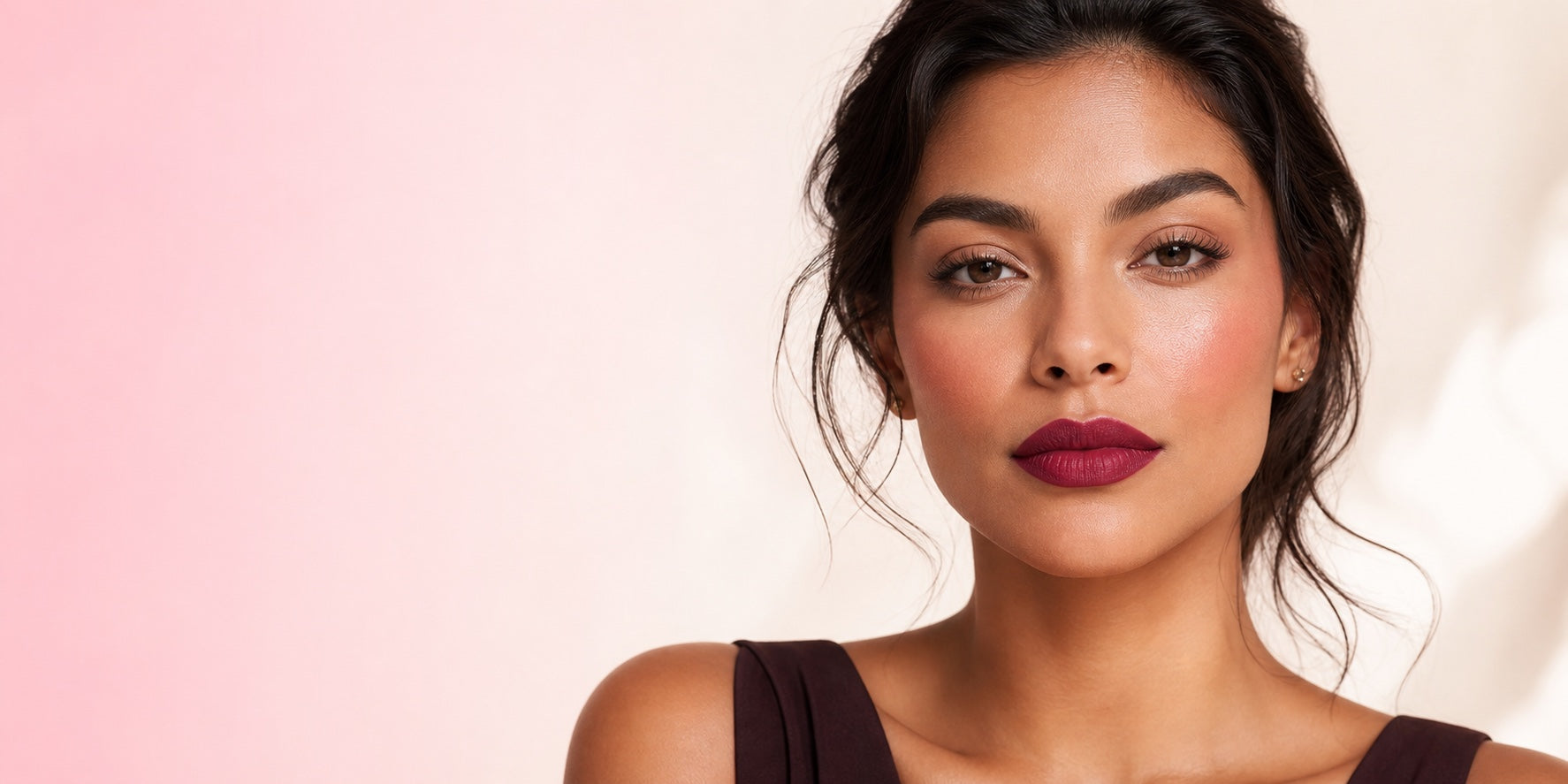 Model wearing a berry lip and rosy blush